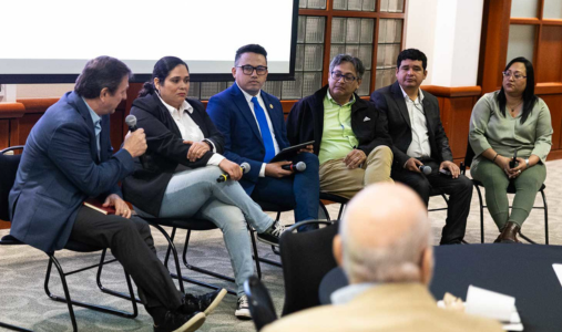 Six people speaking on a panel